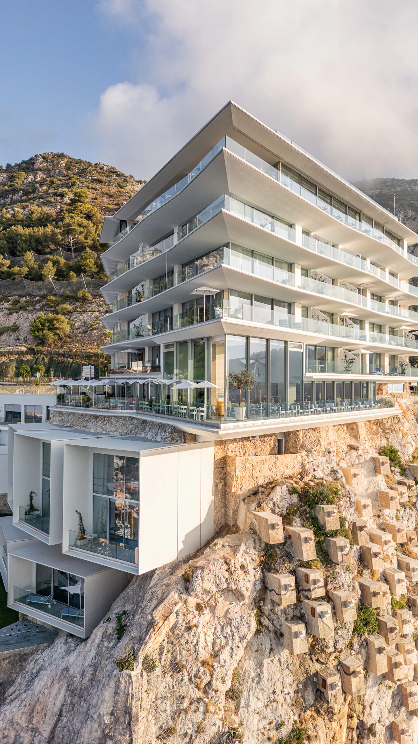 Mediterranean hotel integrated into a coastal cliff