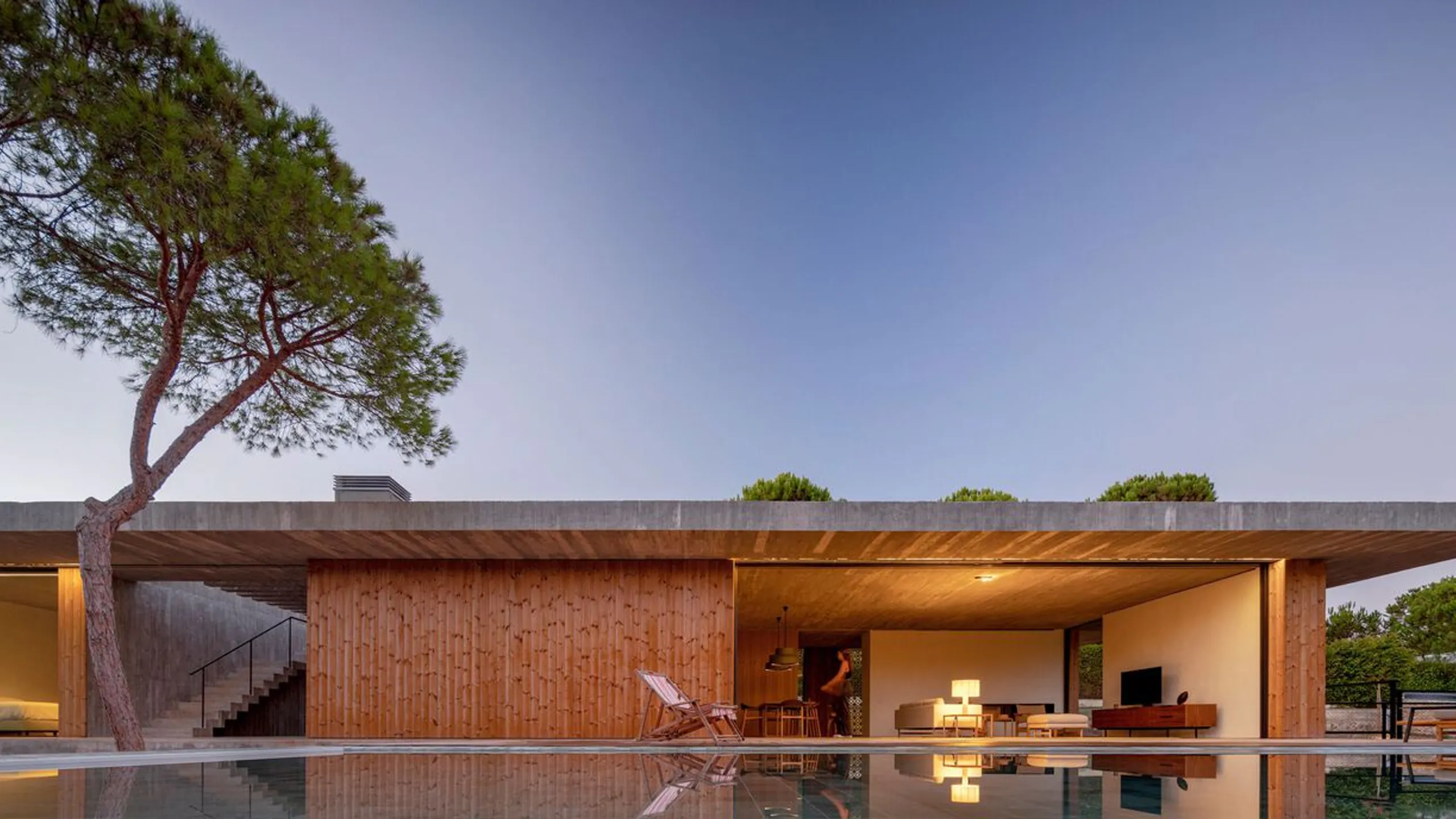 Southern European pavilion embedded in coastal woodland