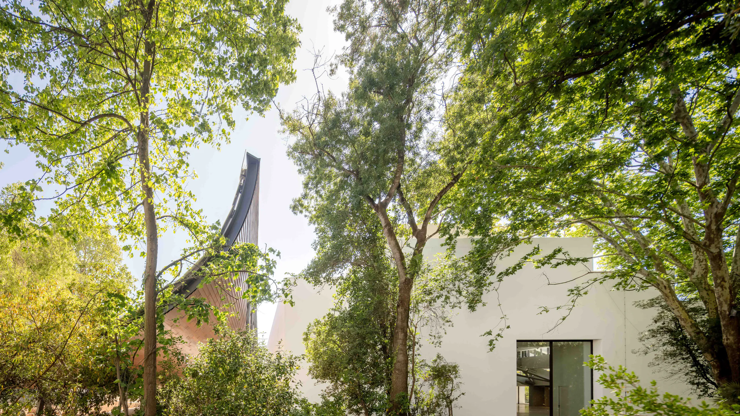 Architectural facade integrated into a mature landscape