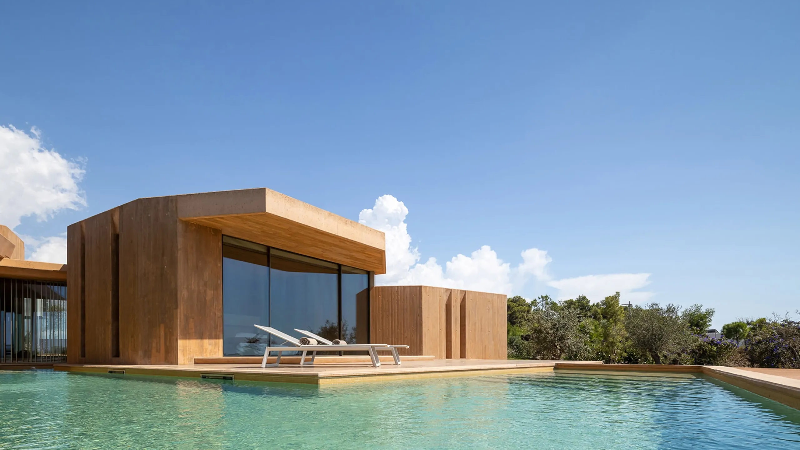 Low coastal villa beside a clear blue pool