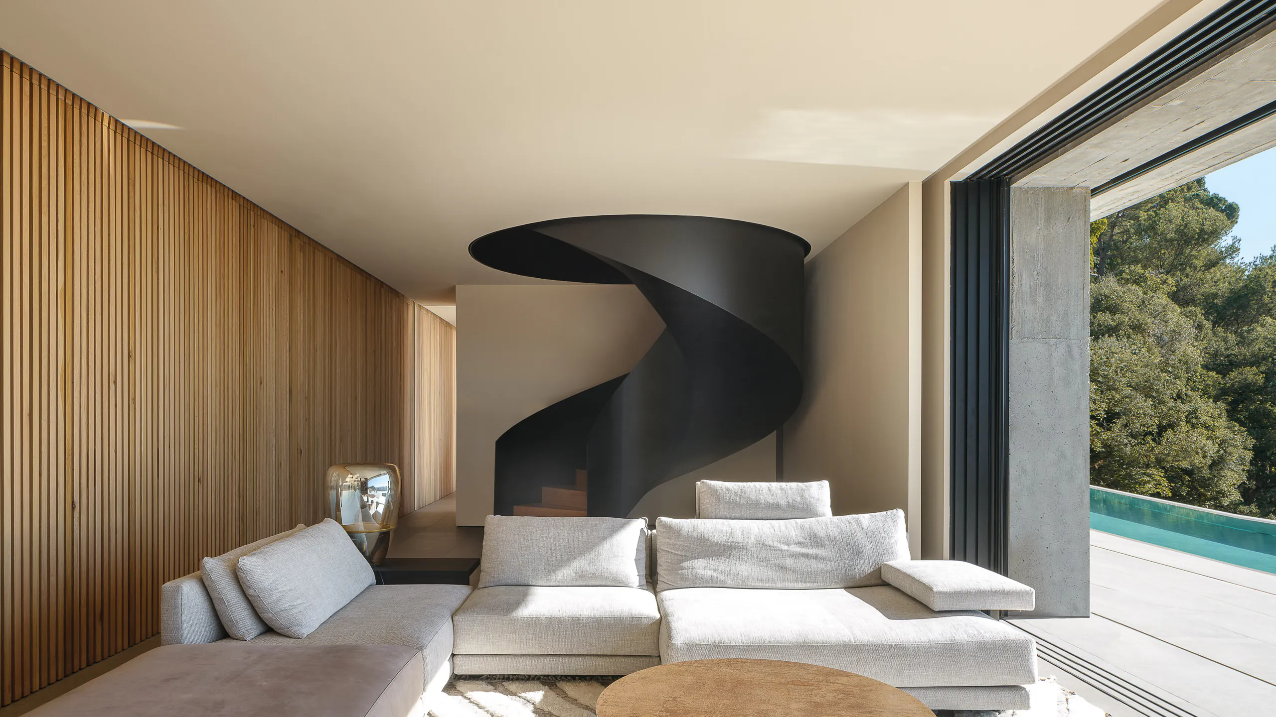 Daylit interior opening directly to a panoramic pool terrace