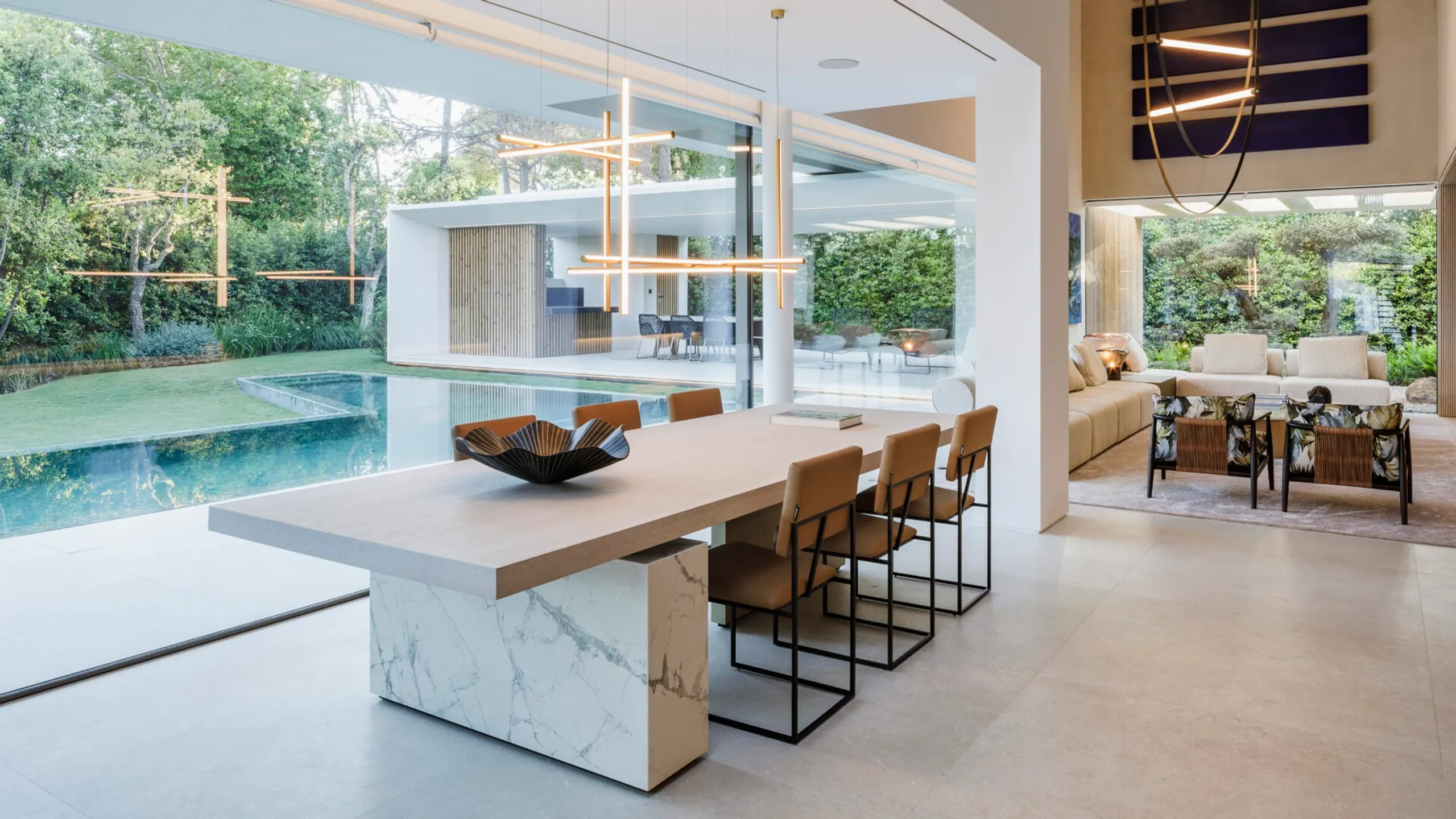 Refined kitchen opening directly to a green pool courtyard