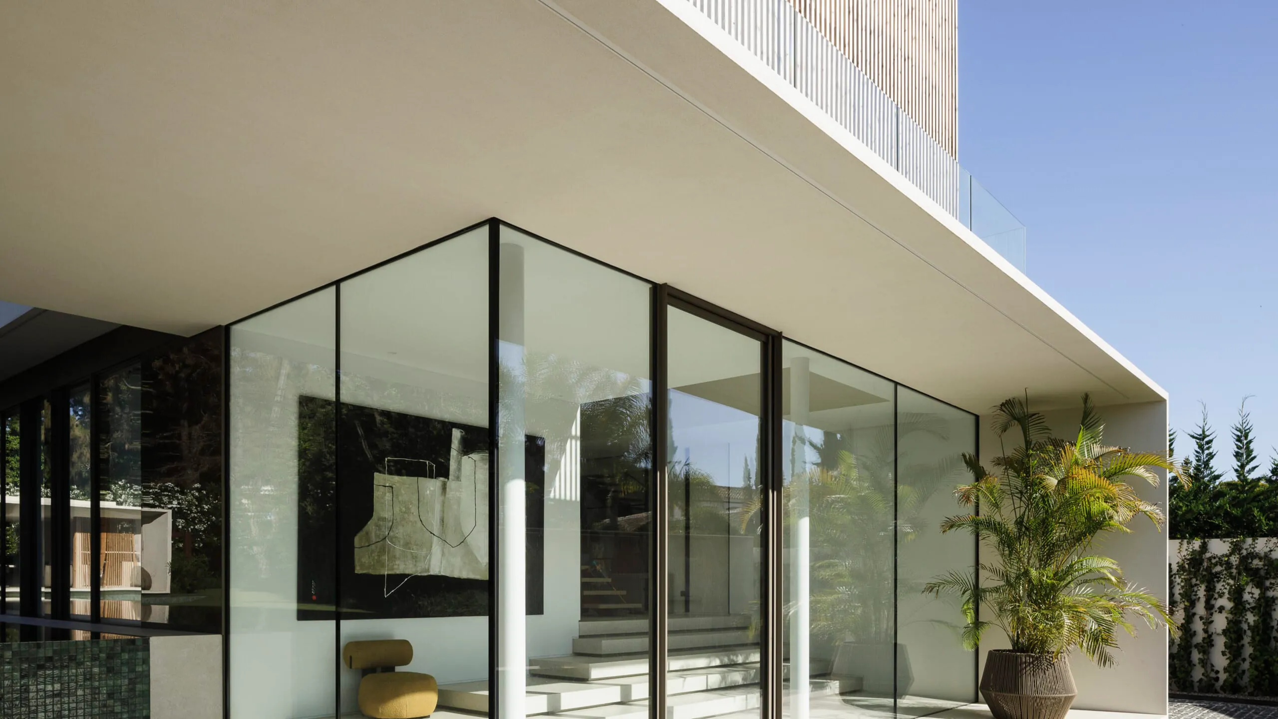 Minimal glazed corner in a sheltered courtyard
