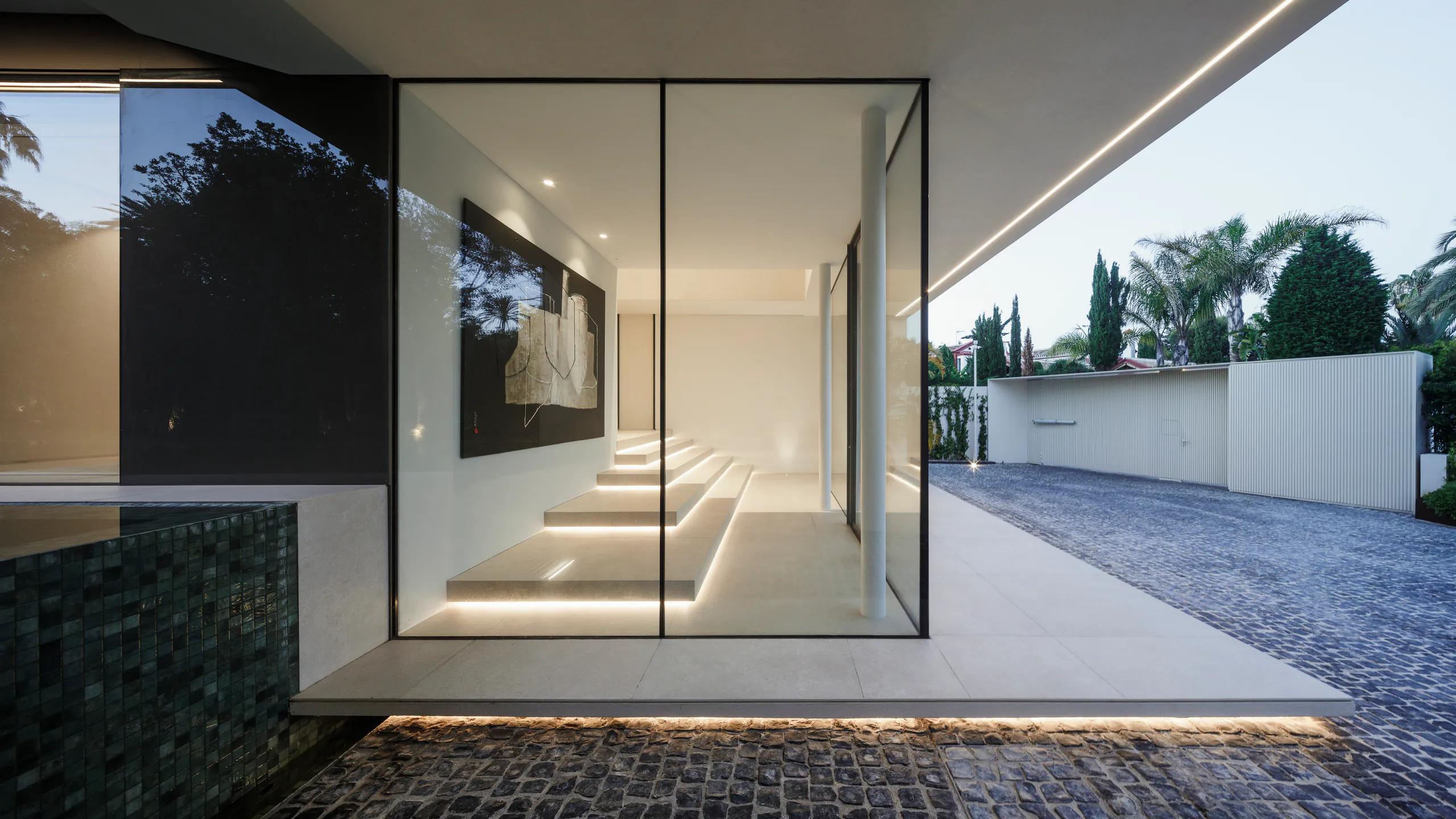 Generous architectural doorway integrated into minimal glazing