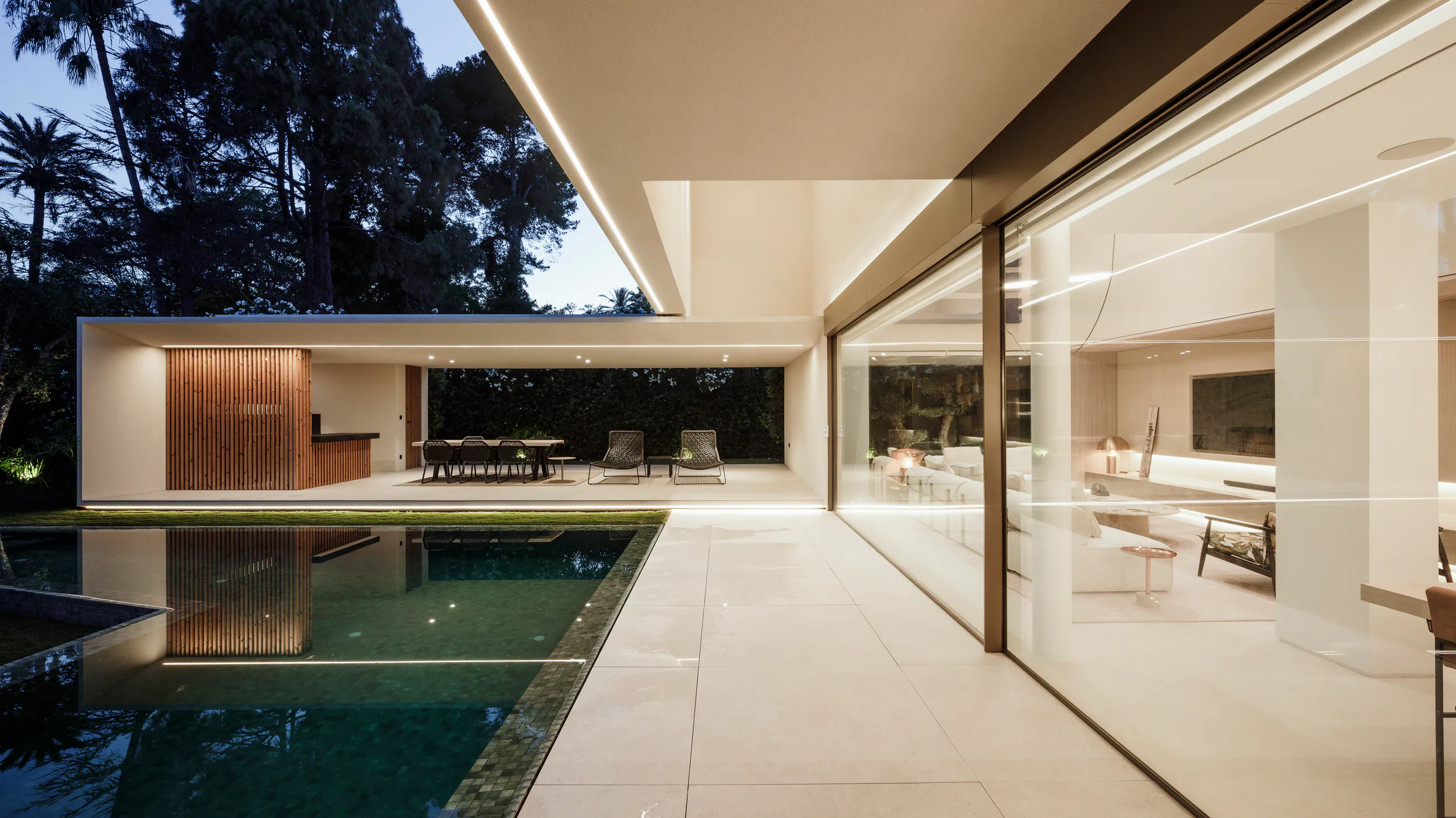 Protected pool courtyard enclosed by minimal glazing