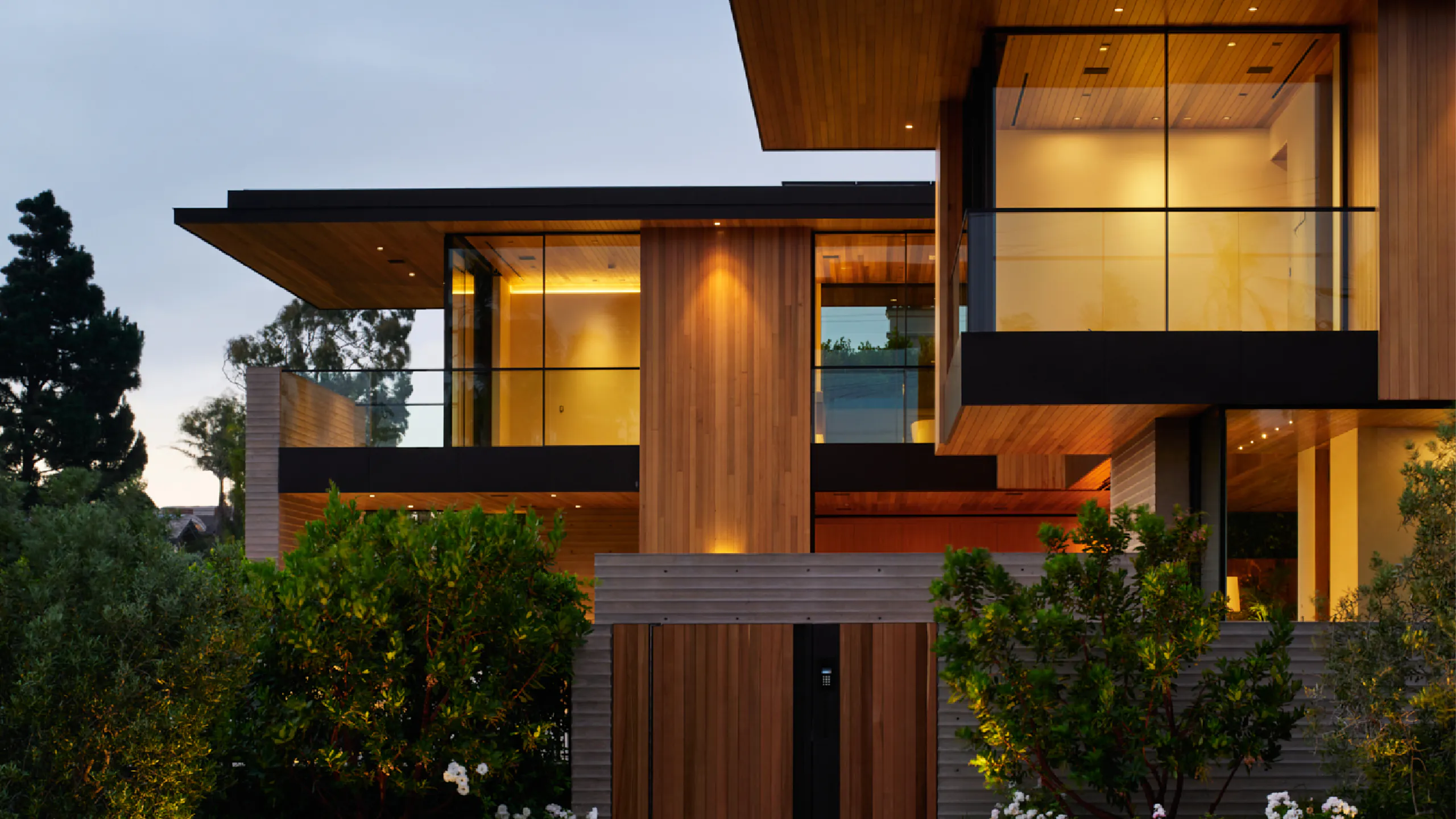 Crafted timber and glass residence at dusk